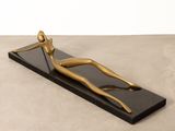 bronze sculpture of a woman on a black base
