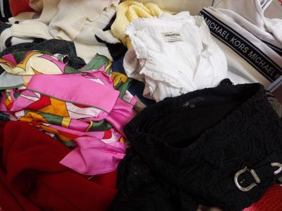 a pile of clothes that is sitting in a suitcase
