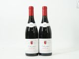 deux bouteilles de vin rouge posées l'une à côté de l'autre sur une surface blanche