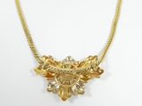 an image of a gold necklace on a white background