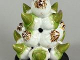 porcelain figurine of a white bird with green leaves on a black base