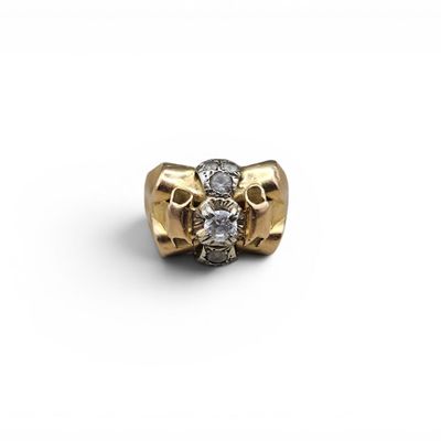 a close up of a gold and diamond ring on a white background