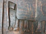 a wooden carving of a man with a hat and an axe