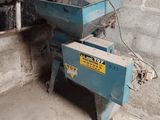 a blue machine that is sitting in the corner of a room