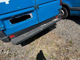 a blue van parked next to a blue van in a parking lot