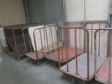four metal beds sitting in a row in a warehouse