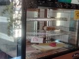 an image of a bakery display case with pastries in it