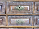 a close up of a wooden dresser with many drawers