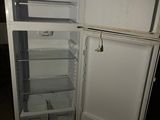 a white refrigerator with its door open in a dark room