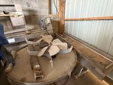 an image of a man working on a machine in a building