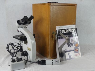 a microscope that is sitting next to a book