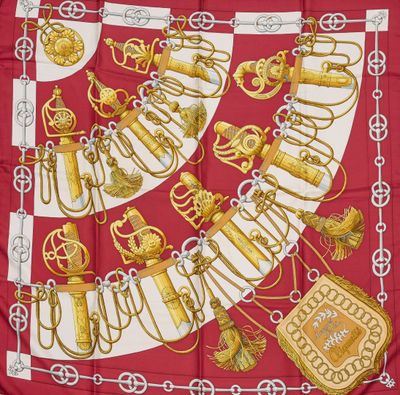 une image représentant une écharpe rouge et blanche ornée de bijoux dorés