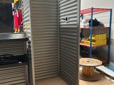 an image of a room with a metal door and shelves