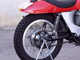 a red and white motorcycle parked in a parking lot