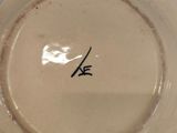 a brown plate with a black writing on it