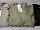 three pairs of men ' s khaki pants with tags on them