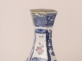 a blue and white vase with a floral design on it