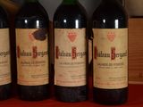 three bottles of wine sitting on a table next to a wooden box