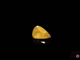 a close up of a yellow diamond on a black background