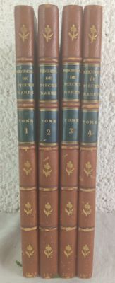 six old books lined up in a row on a table