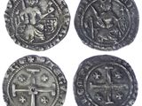four silver coins with a cross and a cross on them