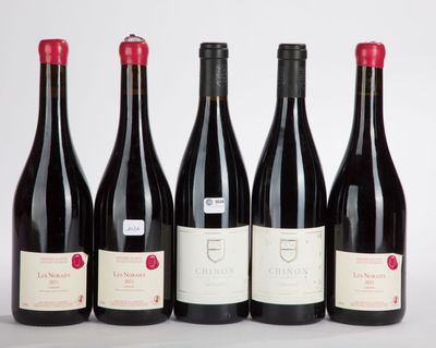 six bottles of red wine are lined up on a white surface