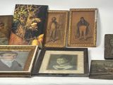 many framed pictures on a table with a white backdrop