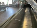 a glass wall in the middle of the walkway