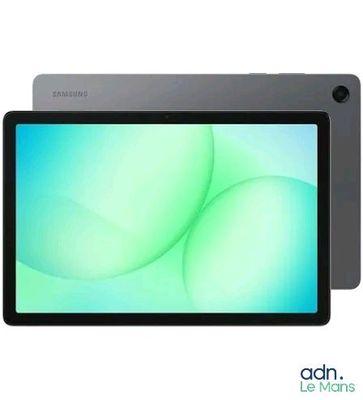 the tablet is sitting on a white surface with a green background