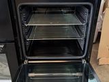 two ovens that are open and one is empty