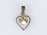 a close up of a heart shaped pendant with a pearl in it