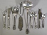 a lot of silver spoons and silverware on the table
