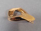 a close up of a gold plated ring on a table