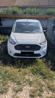 a white car parked in a yard next to a house