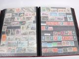 an open book with stamps on it on a table