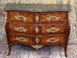 a marble top chest of drawers on a rug