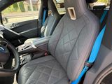 the interior of a car with blue trims and black leather seats