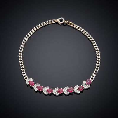 a ruby and diamond necklace on a black background