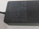 a close up of a laptop charger on a white surface