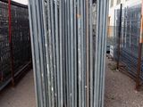 a fence that has a bunch of poles in front of it