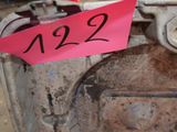 a pink sticker on the side of an old stove