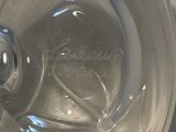 a clear glass bowl with writing on it on a table