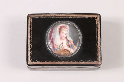 a small black box with a picture of a woman on it