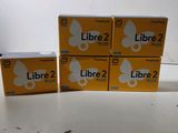 four boxes of libre 2 plus sitting on top of a table