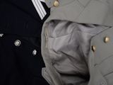 a man wearing a jacket and a tie with buttons on it