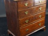 an old wooden chest of drawers with brass handles