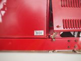 a close up of a red fire hydrant with a sticker on it