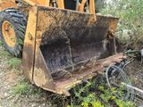 a yellow bulldozer that is sitting in the grass