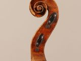 an old violin with a scroll on the back of it