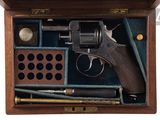 a wooden box with a gun and other items in it